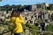 Woman tourist making photo of medieval tuff Sorano town in Italy