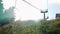 Woman tourist riding on cable ski chairlift to the top of the mountain. Female traveler passing to the mountain pass on ski lift a