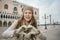 Woman tourist showing heart shaped hands on St. Marks Square