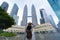 A woman tourist is sightseeing the Petronas Twin tower KLCC in Kuala Lumpur.