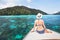 Woman tourist sitting on luxurious boat on paradise tropical beach, holidays travel