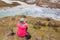 Woman tourist sitting resting Ama Dablam base camp.