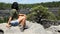 Woman tourist sitting on a rock