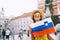 Woman tourist with slovenian flag in Ljubljana, Slovenia, Europe