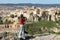 Woman tourist takes pictures of the picturesque houses on the cliff edge of the city of Cuenca