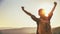 Woman tourist at top of mountain at sunset outdoors during hike