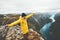 Woman tourist traveling in Norway mountains happy raised hands