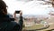 Woman tourist using smart phone, taking picture to urban panorama at Turin, Torino travel destination in Italy.