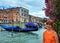 Woman tourist in Venice (view with gondolas)