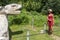 Woman tourist visiting and challenging the God Kulkulcan who is the feathered serpent of the Mayan city of Chichen Itza.