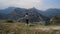 Woman tourist walking hiking in scenery caucasus mountain valley on edge.