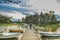 Woman tourist walking in a Peaceful cloud landscape on wooden pathway through the lake water and water reflection