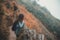 A woman tourist walking and trekking along the mountains in tropical forest