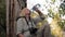 Woman Tourist Was Leaning Back Against A Tree And Drinking Water From Bottle