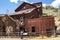 Woman tourists explores the old mining ghost town of Bayhorse Idaho in the Salmon-Challis National Forest