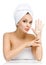 Woman with towel on head shows cream smiley on palm