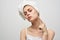 woman with a towel on her head on a light background and pimples on her face transitional age clean skin model