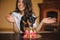 Woman and toy terrier with dog cake infront on birthday party