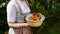 woman in traditional Bavarian dirndl dress holding basket of pretzels (Munich, Bavaria, Germany)