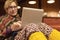 Woman in traditional Clothing using Computer cozy suburban Villa interior