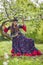 Woman in traditional gypsy dress posing in nature in spring