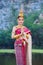 Woman in traditional Thai dress doing gesture we