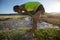 Woman trail runner have a rest on grassland