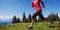 Woman trail runner running on beautiful mountain peak