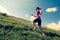 woman trail runner running on mountain trail