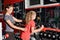 The woman trainer helps the girl when performing exercises with