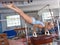 Woman training elements on pommel horse