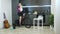 Woman training on stationary bicycle trainer from home and watching online cycling trainings on laptop computer. Female athlete pe