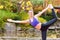 Woman training yoga outdoor in autumn park