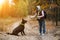 Woman Trains A Dog While Hiking In Forest