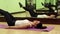 Woman trains in gym. Woman lies on the mat and pumps abdominal muscles