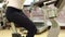 Woman trains in gym. Woman sits on an exercise bike and turns pedals