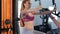 Woman trains her chest muscles on pec deck machine at the fitness centre