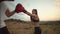 Woman trains her punches on her paws together with a trainer in nature against the sky, bottom view. Woman beats on