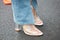 Woman with transparent high heel shoes and torn trousers before Emporio Armani fashion show, Milan Fashion