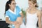 Woman traumatologist doctor in blue suit holds young patient by knee in clinic office portrait