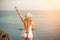 Woman travel bike sea. Happy woman cyclist sitting on her bike, enjoying the beautiful mountain and sea landscape