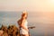 Woman travel bike sea. Happy woman cyclist sitting on her bike, enjoying the beautiful mountain and sea landscape