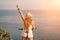 Woman travel bike sea. Happy woman cyclist sitting on her bike, enjoying the beautiful mountain and sea landscape