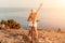 Woman travel bike sea. Happy woman cyclist sitting on her bike, enjoying the beautiful mountain and sea landscape