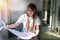 Woman travel holding map in train near window. Traveler young girl expressing positivity hold generic map navigation