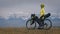 The woman travel on mixed terrain cycle touring with bikepacking. The traveler journey with bicycle bags. Sport tourism