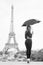 woman travel in paris, france. Woman with fashion umbrella. Girl with beauty look at eiffel tower. Parisian