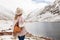 Woman traveler on the background of a mountain lake