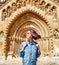 Woman traveler with backpack admiring tourist sights and destinations in Europe. Jaki chapel in Vajdahunyad castle in