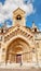 Woman traveler with backpack admiring tourist sights and destinations in Europe. Jaki chapel in Vajdahunyad castle in